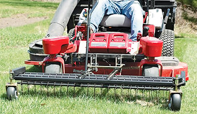 landscaper dethatching lawn