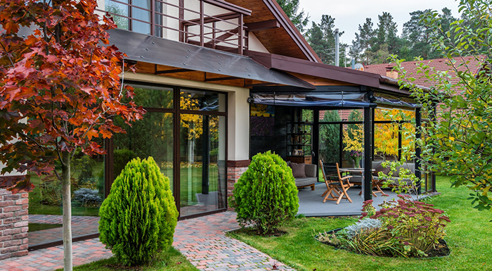 A yard with lots of trees and a patio.