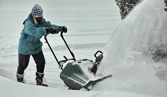 “  A woman hard at work after choosing the right snowblower