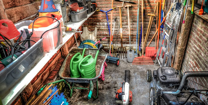 A collection of equipment in a shed you’ll need to meet your lawn goals
